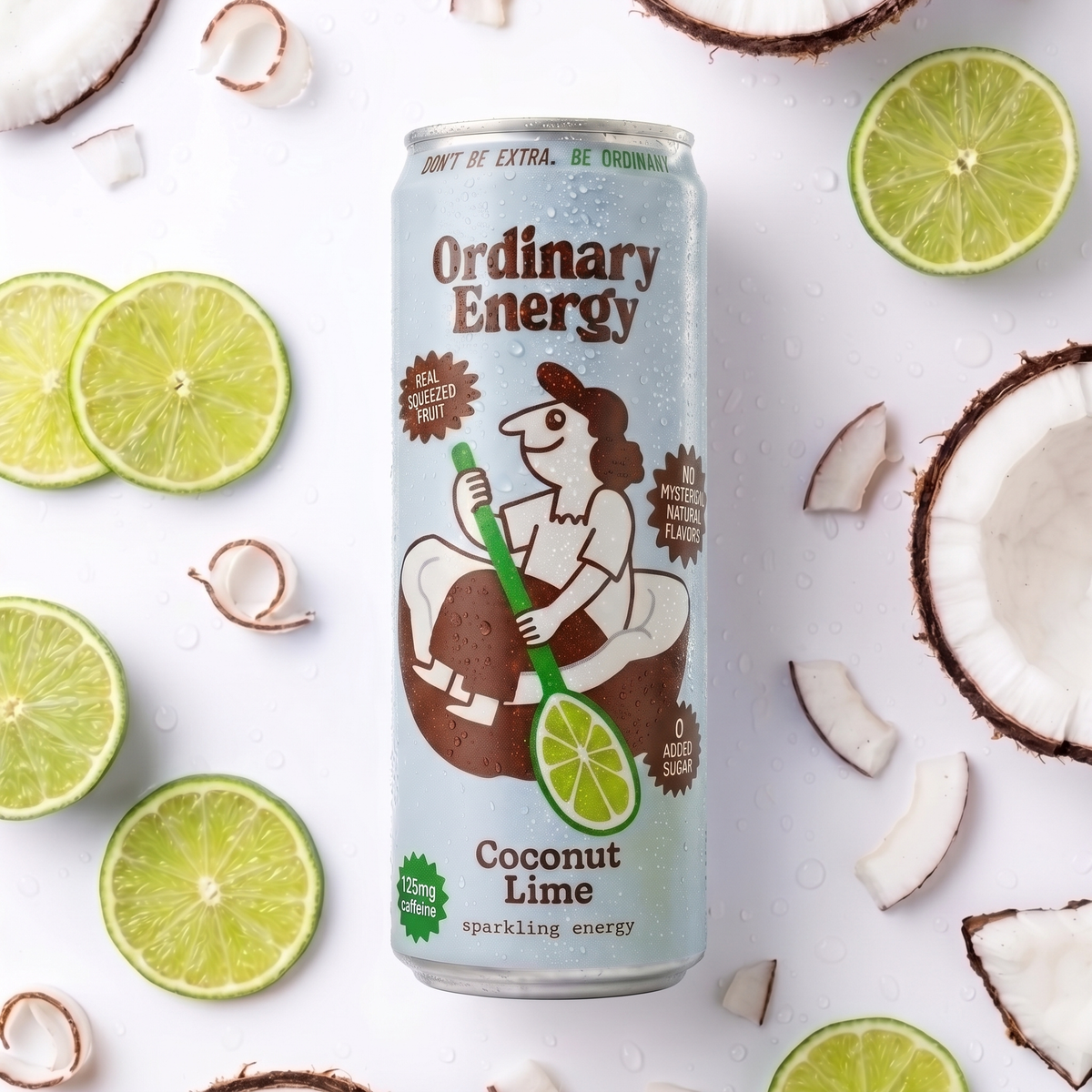 Can of Ordinary Energy Coconut Lime surrounded by lime slices and coconut pieces